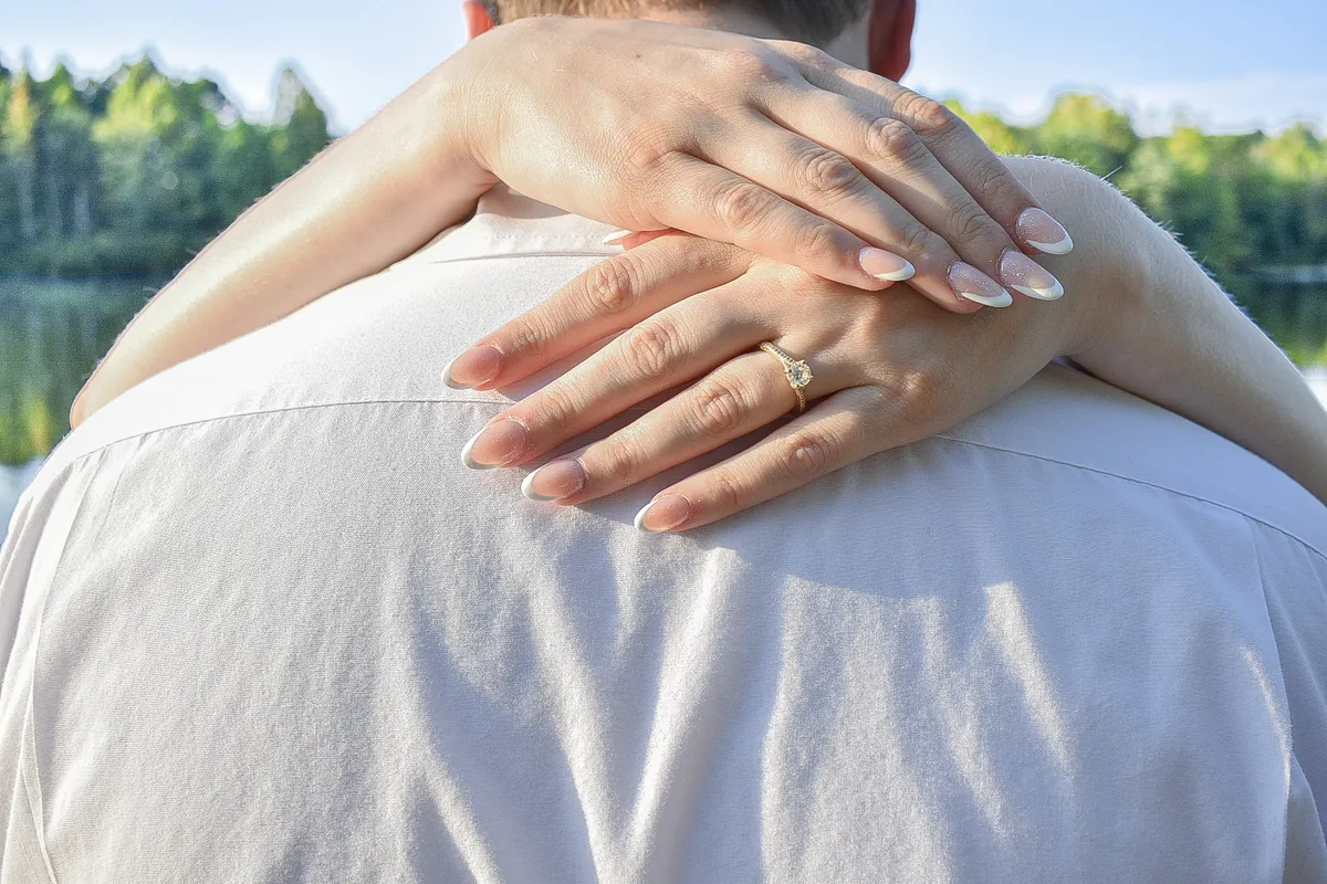 Alyssa's engagement ring, her hands resting on Landon's shoulder